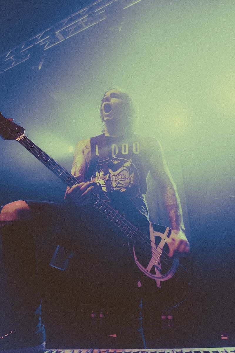 guitar man playing bass guitar on stage leisure activities